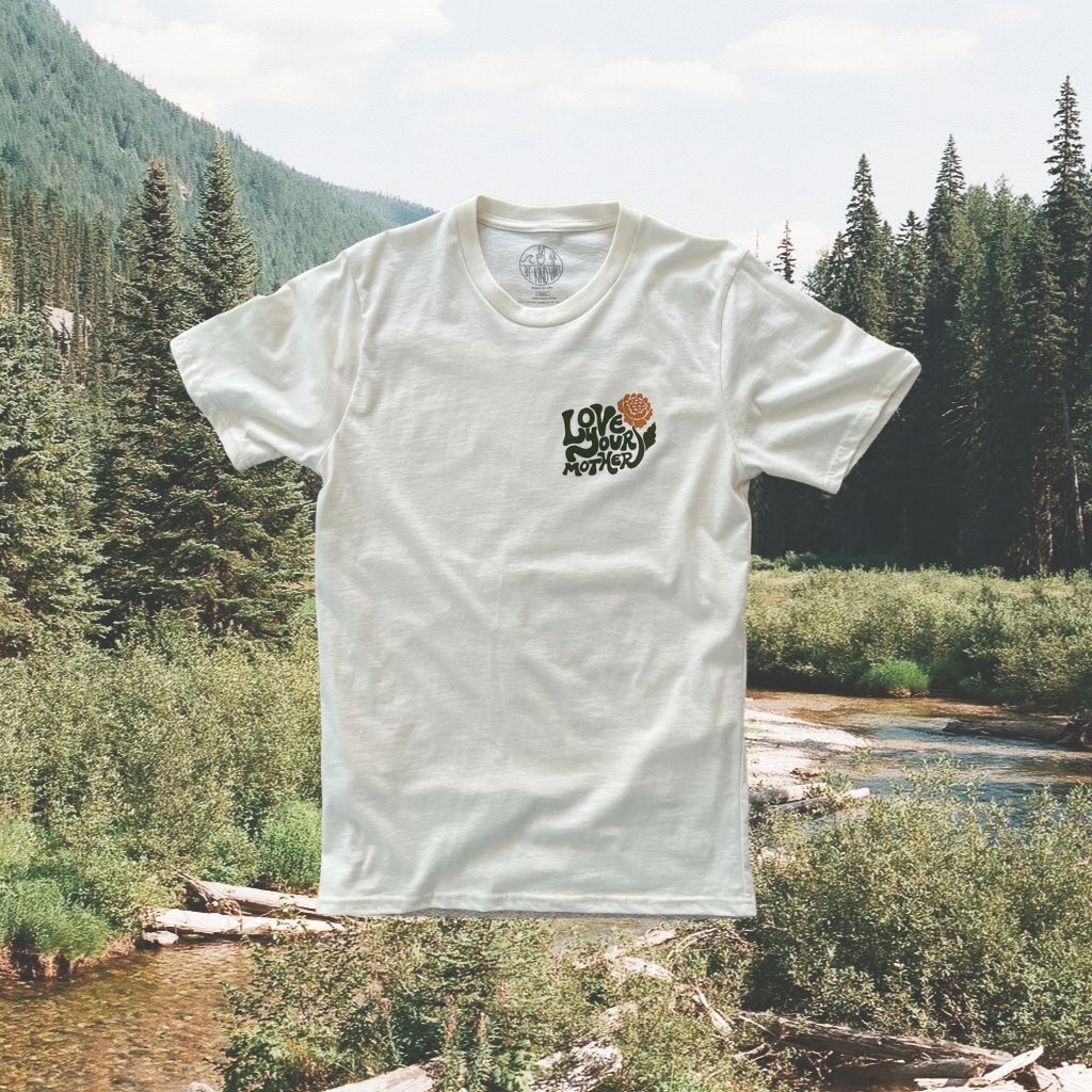 Image features the sustainably made 100% organic cotton Love Your Mother tee by Be Kind Vibes overlaid on a photo of the British Columbia wilderness.