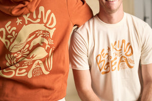Image features two models wearing the Be Kind Vibes To the Sea hoodie and the To the Sea t-shirt. 