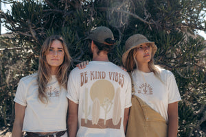 hero image featuring the front and back of 3 models wearing the 100% organic cotton Desert Waves tee by Be Kind Vibes