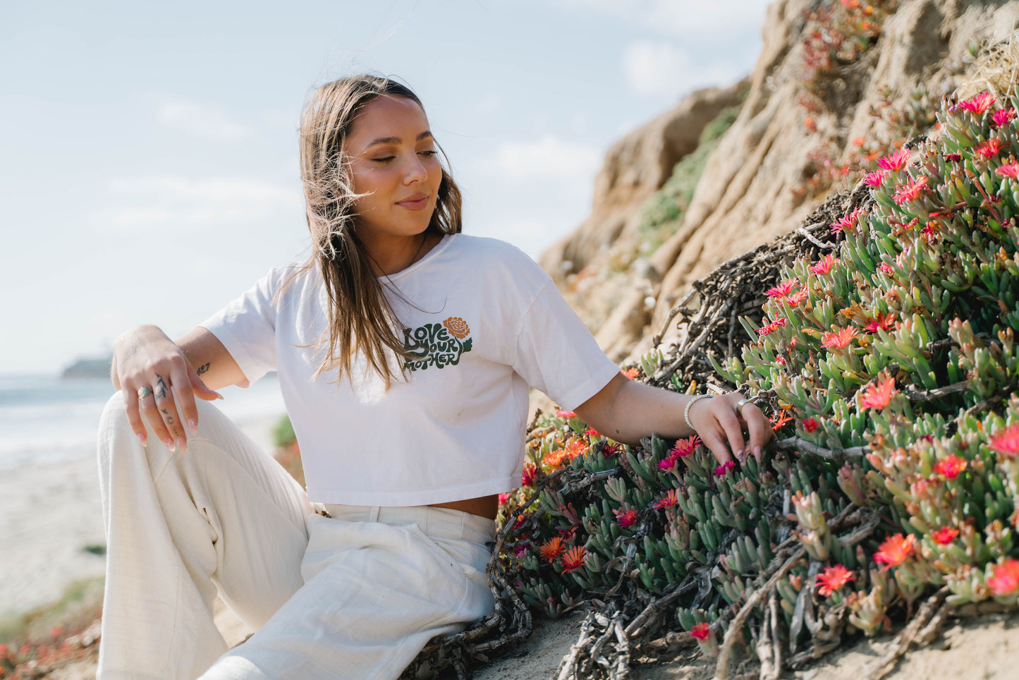 Image features two models wearing the Be Kind Vibes To the Sea hoodie and the To the Sea t-shirt. 