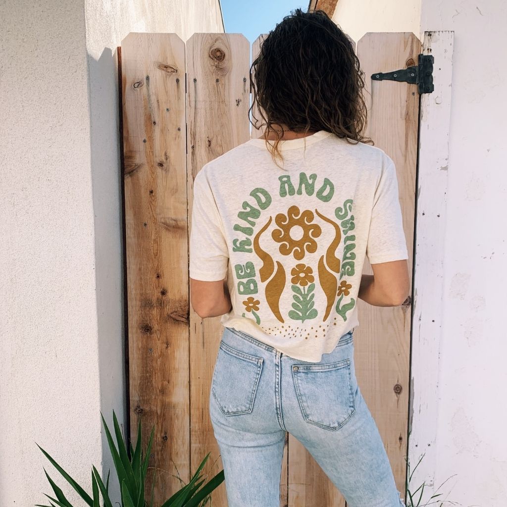 Image features the back of a female model wearing blue jeans and the sustainably made hemp and organic cotton Be Kind & Shine crop top in natural from Be Kind Vibes.
