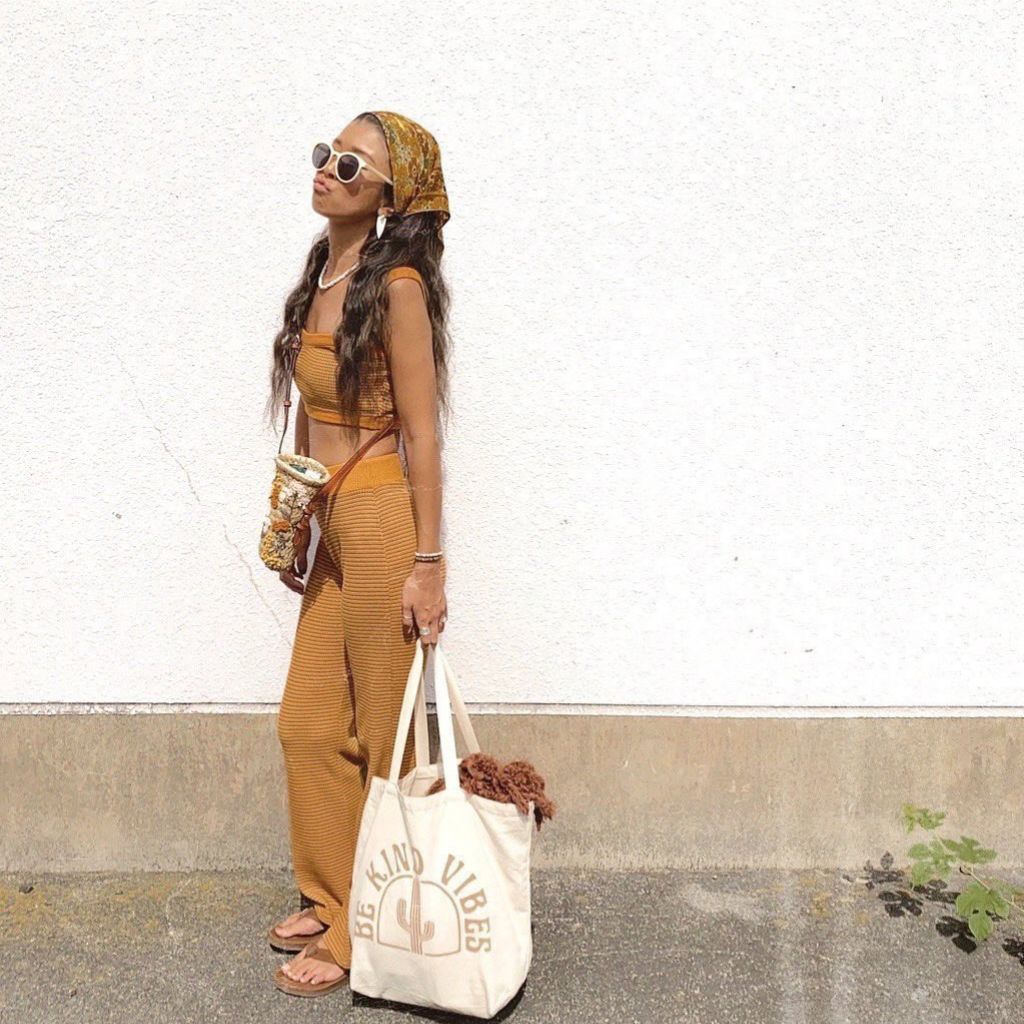 
                  
                    Image features a female model holding the Be Kind Vibes ethically made Desert Tote bag while she leans against a white wall
                  
                