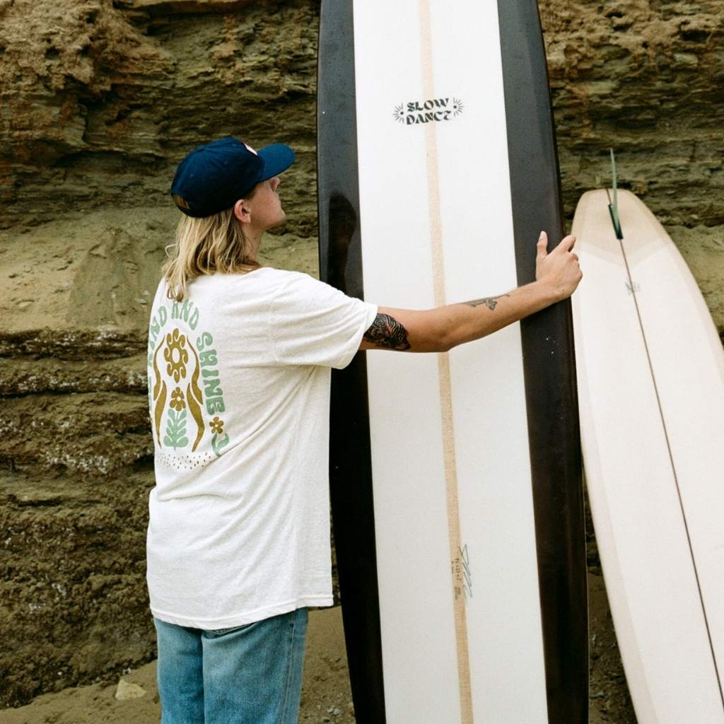 Hero image featuring the back of a male model wearing the Be Kind Vibes sustainably made Be Kind & Shine tee