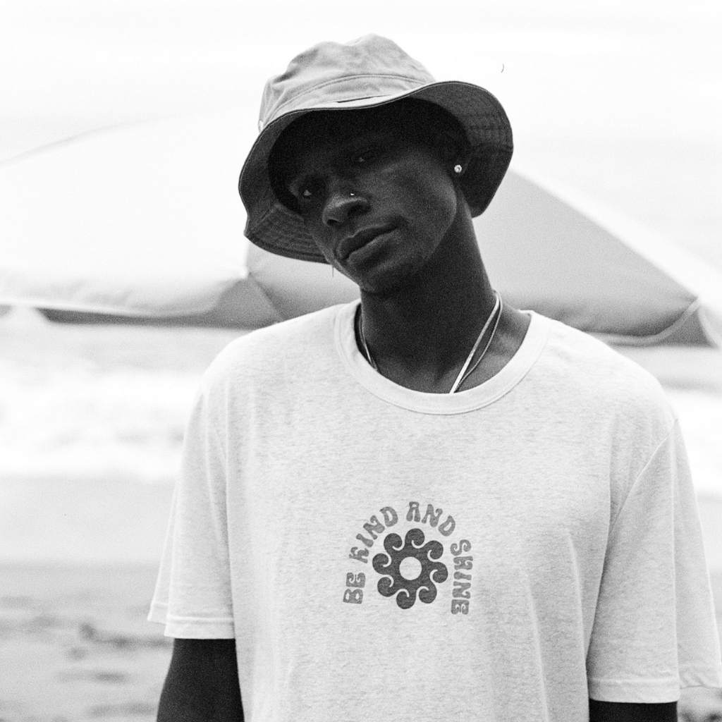 Hero image featuring a male model wearing the Be Kind Vibes Be Kind & Shine sustainably made tee